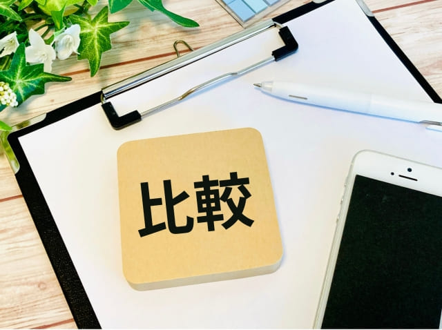 「比較」と印字されたコースターとスマホ